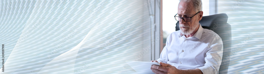 Fototapeta premium Senior businessman using a digital tablet. panoramic banner