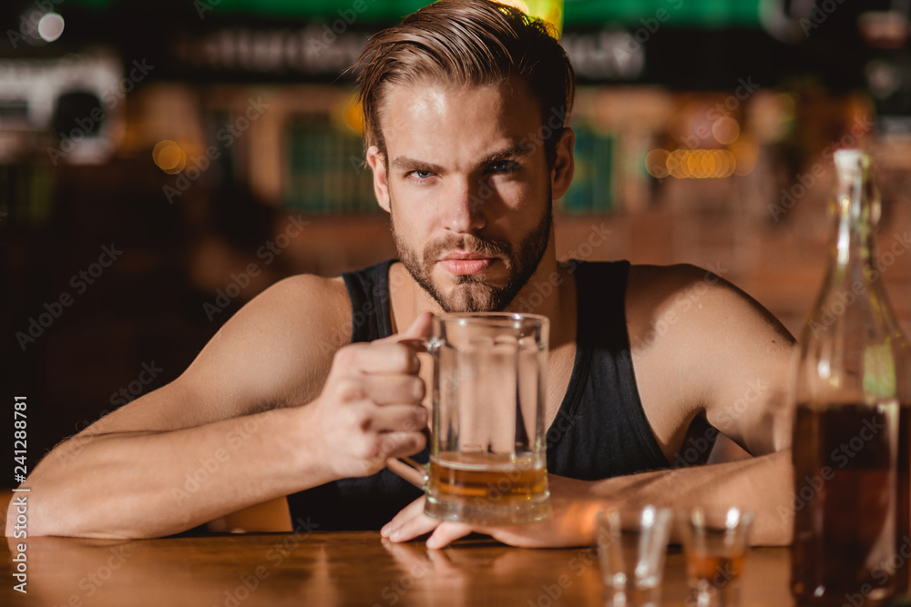 He is a big fan of beer. Addicting to alcoholic drink. Alcohol addict with beer mug. Man drinker in pub. Handsome man drink beer at bar counter. Beer restaurant. Alcohol addiction and bad habit