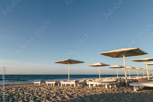 Sea beach with sunbeds and umbrellas