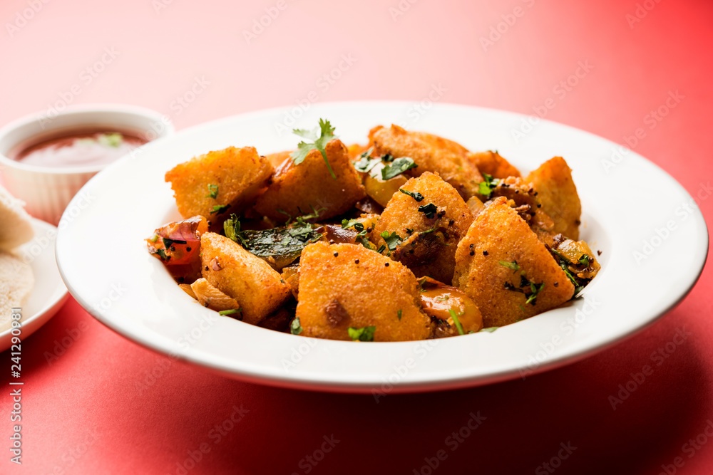 Masala fried Idlies or Idli fry - south indian Snack made using with leftover idly served with tomato ketchup. selective focus Masala fried Idlies or Idli fry - south indian Snack made using with leftover idly served with tomato ketchup. selective focus
