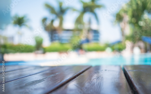 Blur wooden table on pool background,