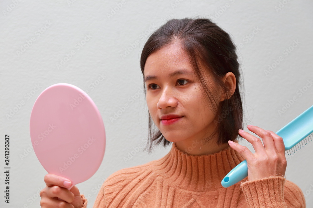 young woman using a hand mirror young woman using a hand mirror