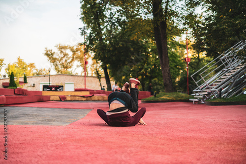 male athlete practising parkour in the street in summer day b