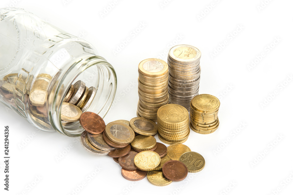 Coins spilled out of a jar. Savings concept