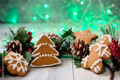 ginger biscuit on white background with Christmas tree , candles and christmas lights