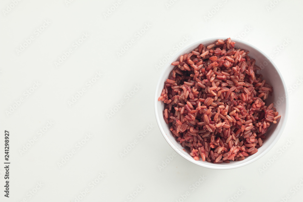 Red Cargo Rice garnished in white bowl on white desk Red Cargo Rice garnished in white bowl on white desk