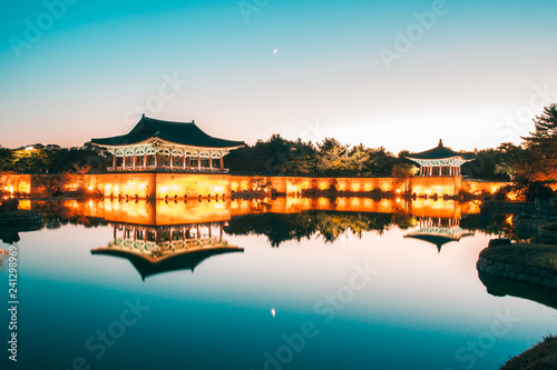 The pavilions of Anapji Pond reflected in the water in Gyeongju.The Gyeongju Historic Areas of South Korea were designated as a World Heritage Site by UNESCO in 2000, ref 976. Teal and orange view. © tanaonte