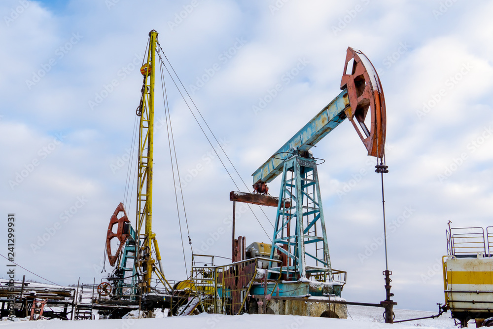 Mining and quarrying. Installations for the extraction of oil from the bowels of the Earth. Pumpjack is the overground drive for a reciprocating piston pump in an oil well. Mining and quarrying. Installations for the extraction of oil from the bowels of the Earth. Pumpjack is the overground drive for a reciprocating piston pump in an oil well.