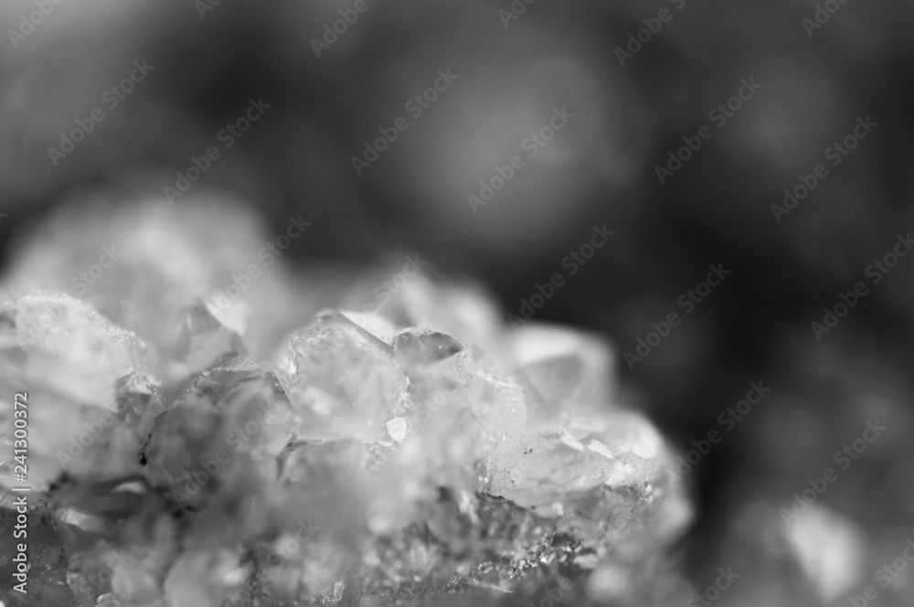 Black and white photograph of the structure of the surface of crystals. Close-up. Blurred background. Black and white photograph of the structure of the surface of crystals. Close-up. Blurred background.