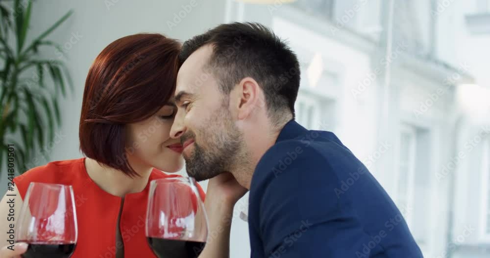 Close up of the romantic attractive couple in love having a lunch and sharing lovely moment together. Portrait. Close up of the romantic attractive couple in love having a lunch and sharing lovely moment together. Portrait.