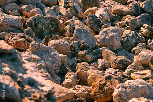 Multi-colored stones boulders on the seashore