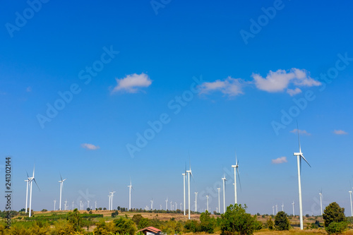 Windmill electric turbine field under blue sky