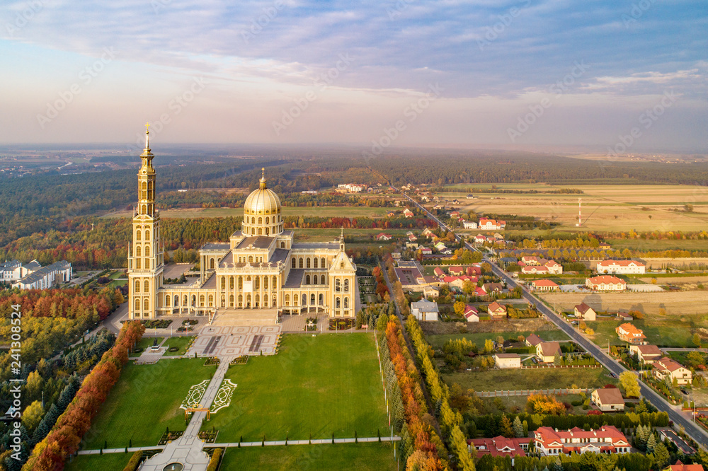 Village Lichen in Poland with Sanctuary and Basilica of our Lady of Licheń. The biggest church in Poland, one of the largest in the World. Famous pilgrimage site. Aerial view in fall. Sunset light