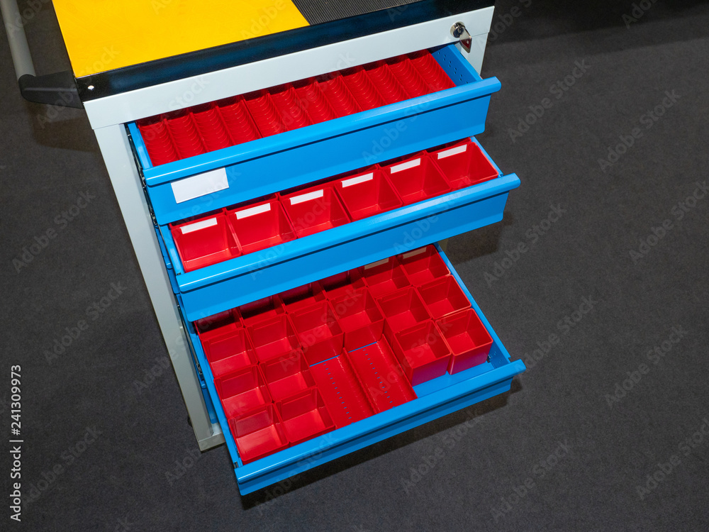 Toolbox. Retractable shelves with containers. storage of spare parts.  Organizer for hardware. Storage of hardware. Stock Photo