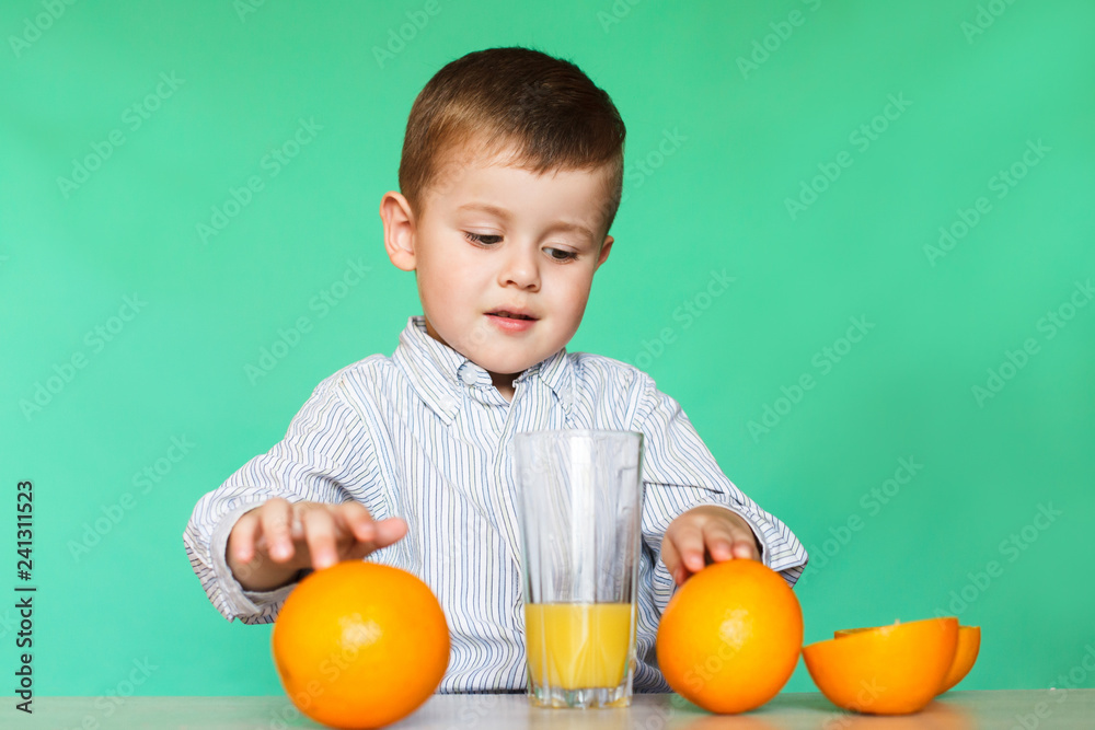 Little boy with oranges and juice.