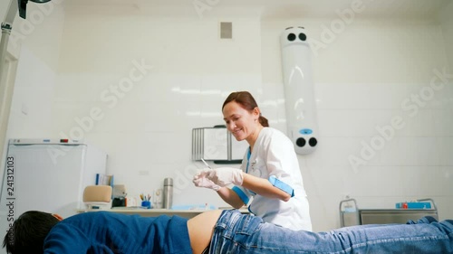 Woman doctor makes an intramuscular injection to the gluteus maximus muscle. photo