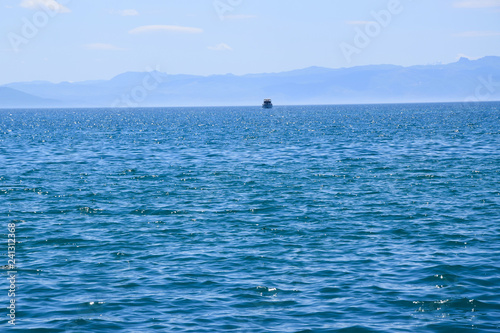 Wave on Ohrid Lake with mountain and ship background. Ohrid, Macedonia.