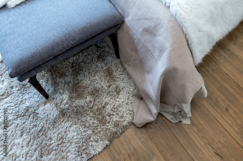 Synthetic carpet on the laminate in the home interior. Close-up photo