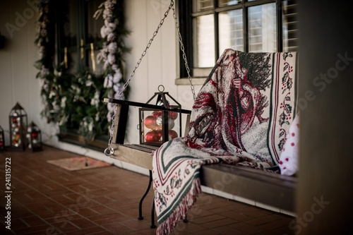 front porch with swing decorated for christmas
