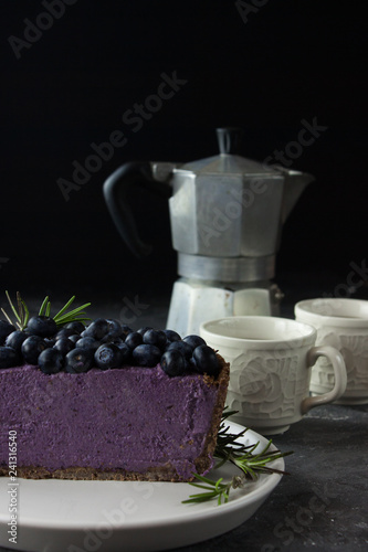 Blueberry vegan cheesecake. Dark photo on black background photo