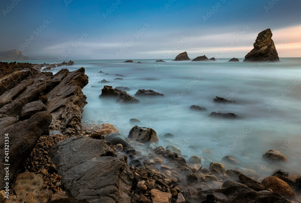 Dragon Rocks of Mupe Bay at sunset, Jurassic Coast, Dorset. North sea. England. Long exposure photography Dragon Rocks of Mupe Bay at sunset, Jurassic Coast, Dorset. North sea. England. Long exposure photography
