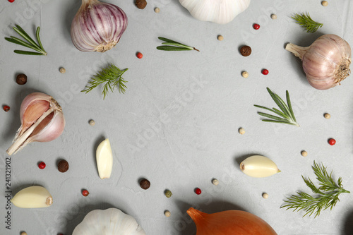 Flat lay composition with garlic, onion and space for text on table