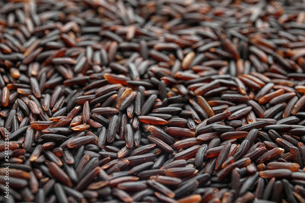 Pile of uncooked black rice as background, closeup Pile of uncooked black rice as background, closeup