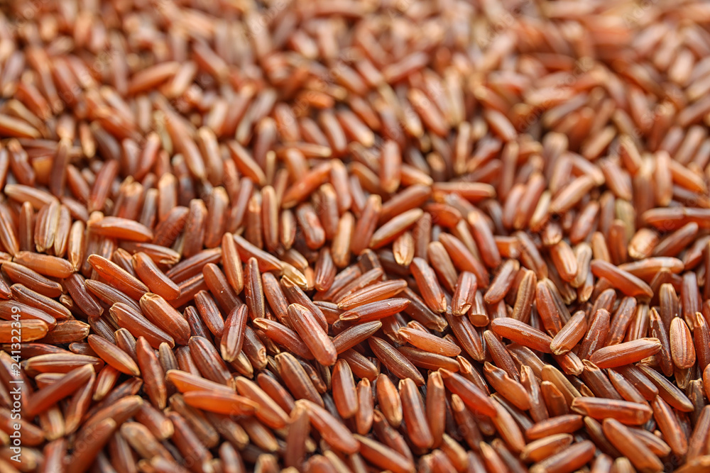 Pile of uncooked red rice as background, closeup Pile of uncooked red rice as background, closeup