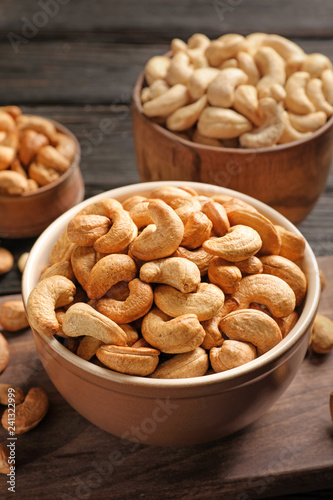 Bowl with cashew nuts on wooden table