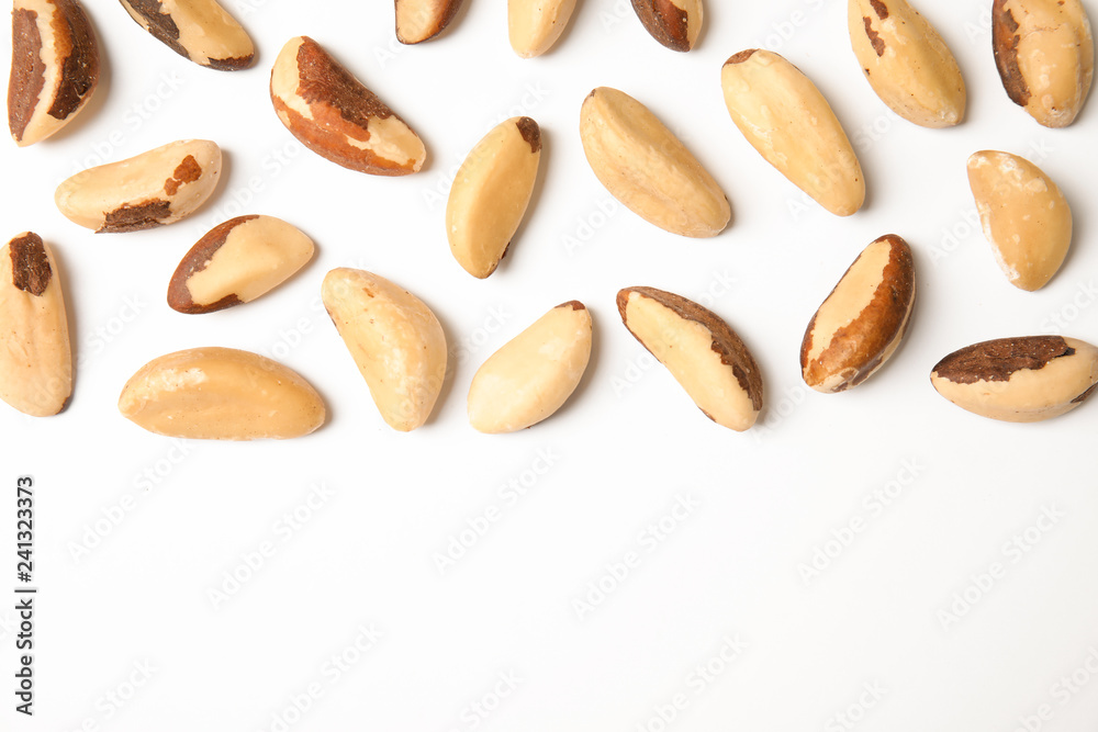 Composition with Brazil nuts and space for text on white background, top view