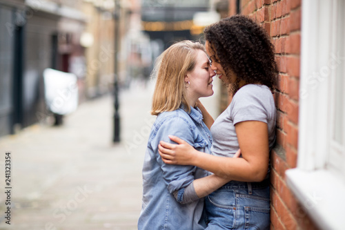 lesbian couple kissing in the street