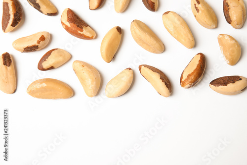 Composition with Brazil nuts and space for text on white background, top view