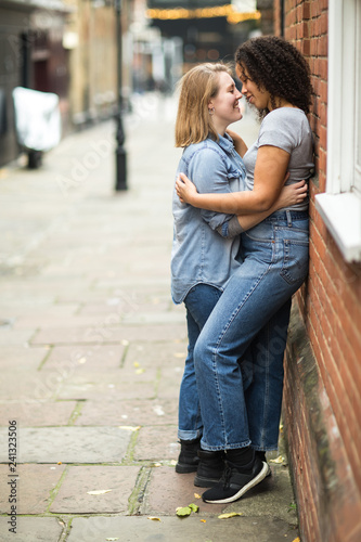 Lesbian couple kissing in the street © michael spring
