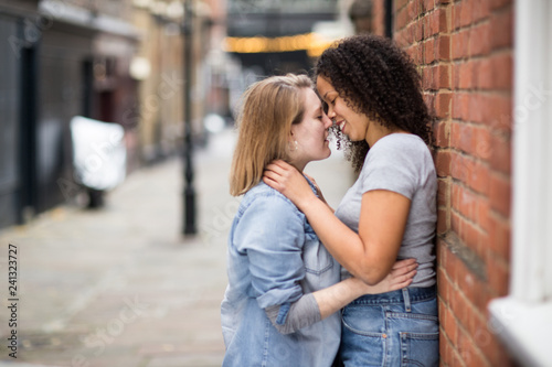 Lesbian couple kissing in the street