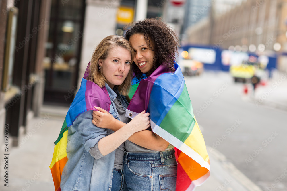 lesbian couple with a rainbow flag