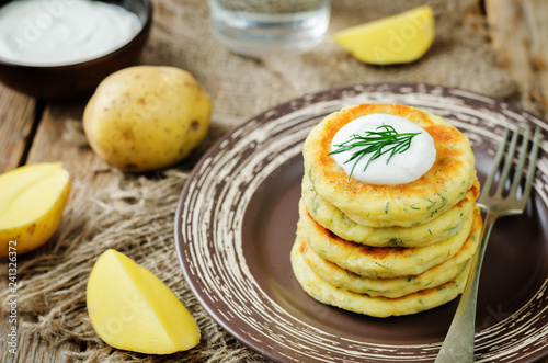 Cheese mashed potato cakes with sour cream and fresh dill