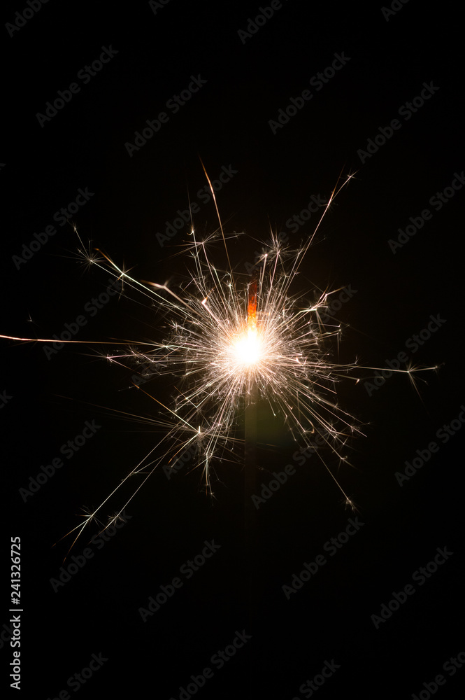 Obraz premium Hand fireworks sparkler on black background.