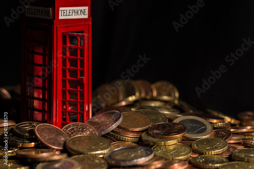 brexit concept - telephone kiosk, coins photo