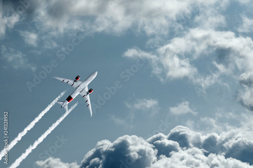 The plane against the blue sky and fluffy clouds. Concept of vacation  vacation  flight  travel.