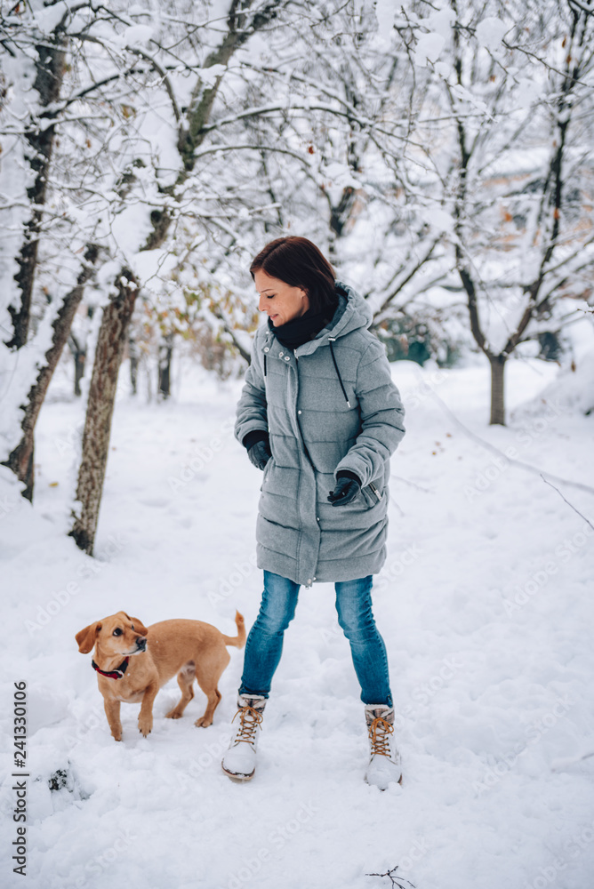 Woman with a dog on a snow