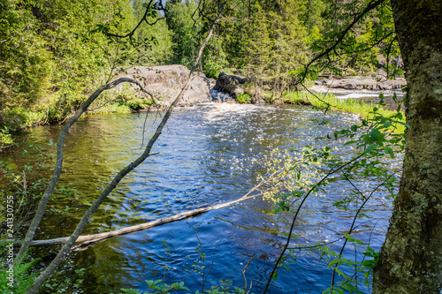 Foamy streams of water Tahmayoki River on the waterfall Ahinkoski