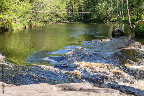 Foamy streams of water Tahmayoki River on the waterfall Ahinkoski