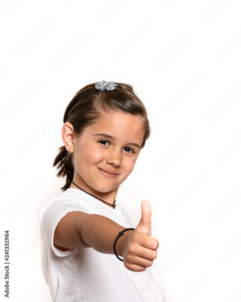 Young primary school aged school girl showing thumbs up. Focus on face Young primary school aged school girl showing thumbs up. Focus on face