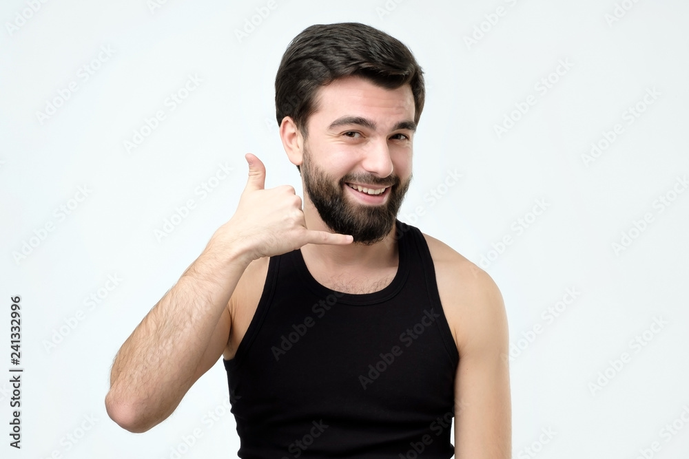 Young handsome man making call me sign Young handsome man making call me sign