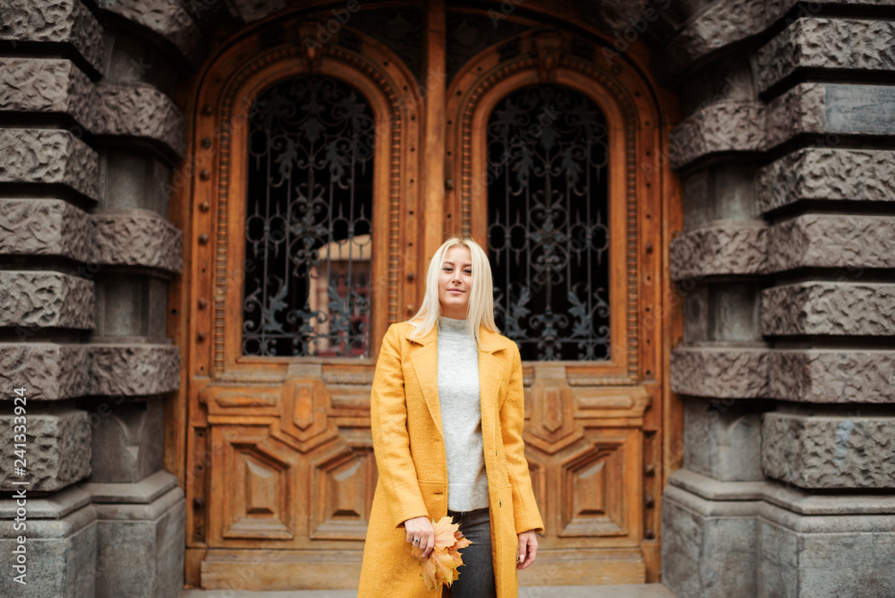 Beautiful elegant woman standing in the street in autumn , Fall concept