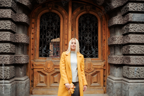 Beautiful elegant woman standing in the street in autumn , Fall concept