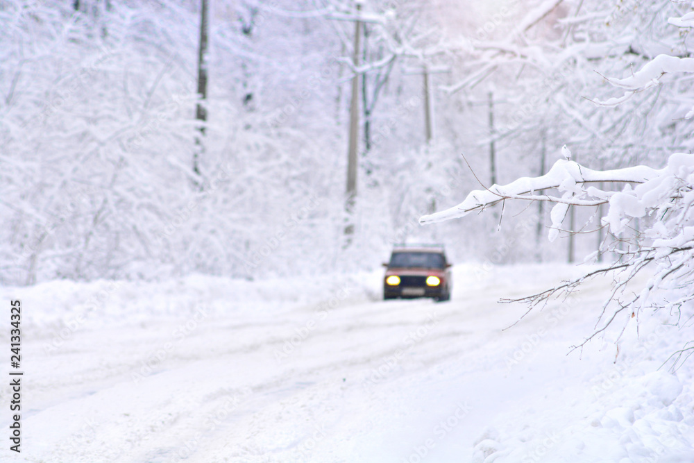 Deep winter scene on a country frozen road with car. Blurred background. Deep winter scene on a country frozen road with car. Blurred background.