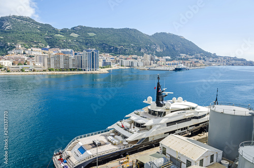 Harbor and the Bay of Gibraltar with a densely populated town area and a luxury yacht Alfa Nero