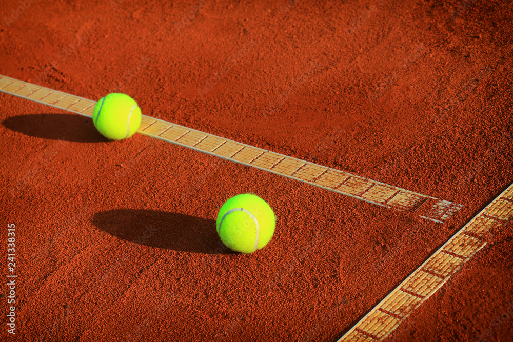 Tennis balls on a tennis clay court