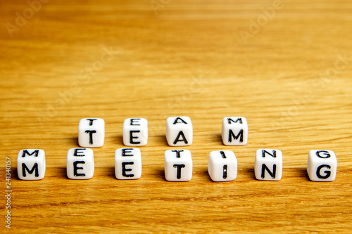 little miniature figurines with little dices forming word team meeting as a part of team meeting collection pictures